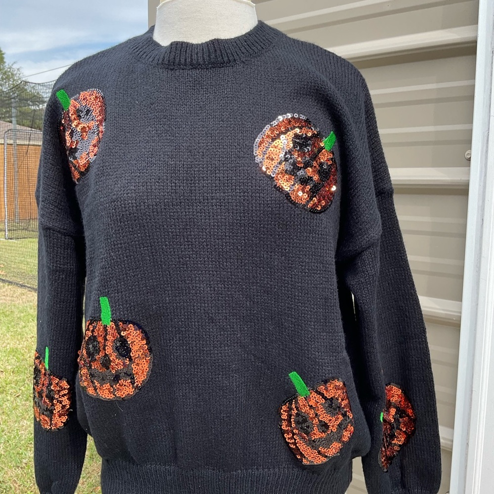 Black sweater with sequin pumpkin details. TTS Jess Lea